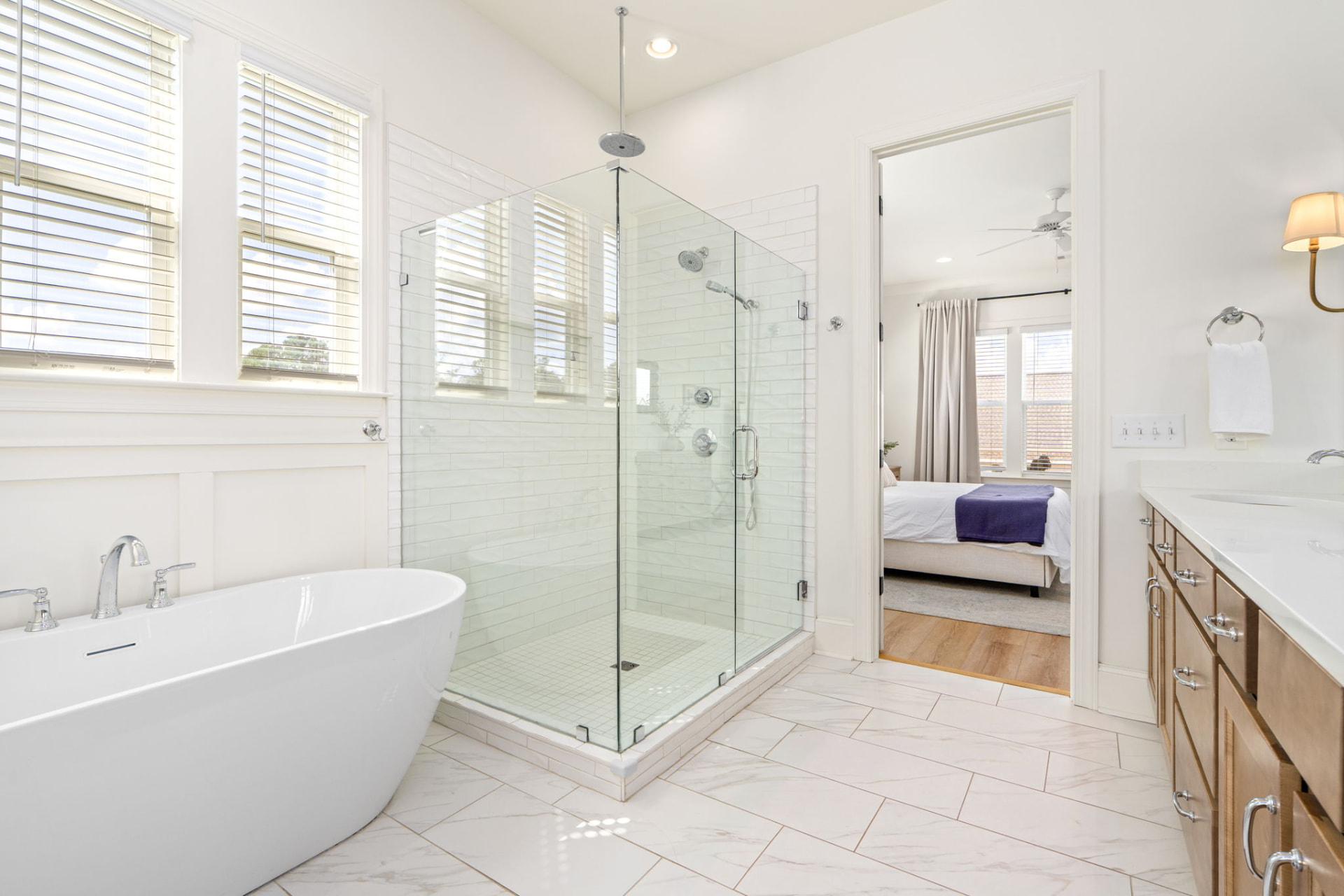 Primary bathroom with a freestanding soaking tub, glass walk-in shower and wood double vanity