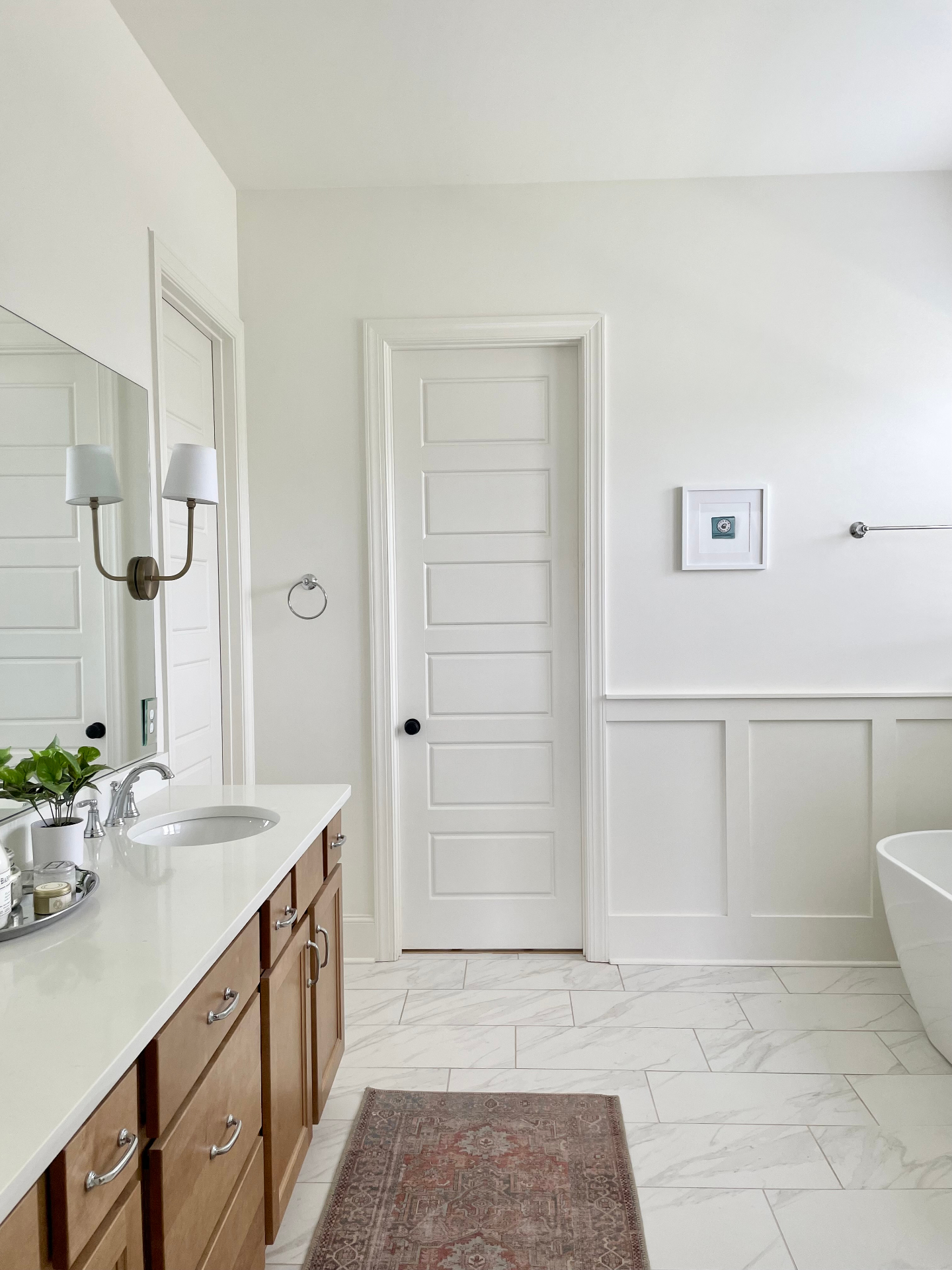 Primary bathroom entry with tile flooring and a glass shower