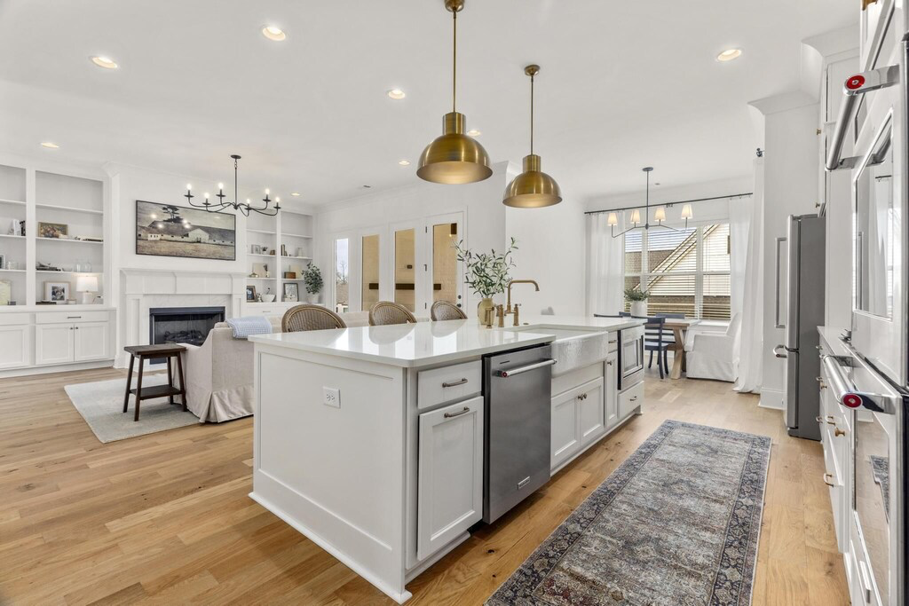 Kitchen open to the living room with bar seating at the island