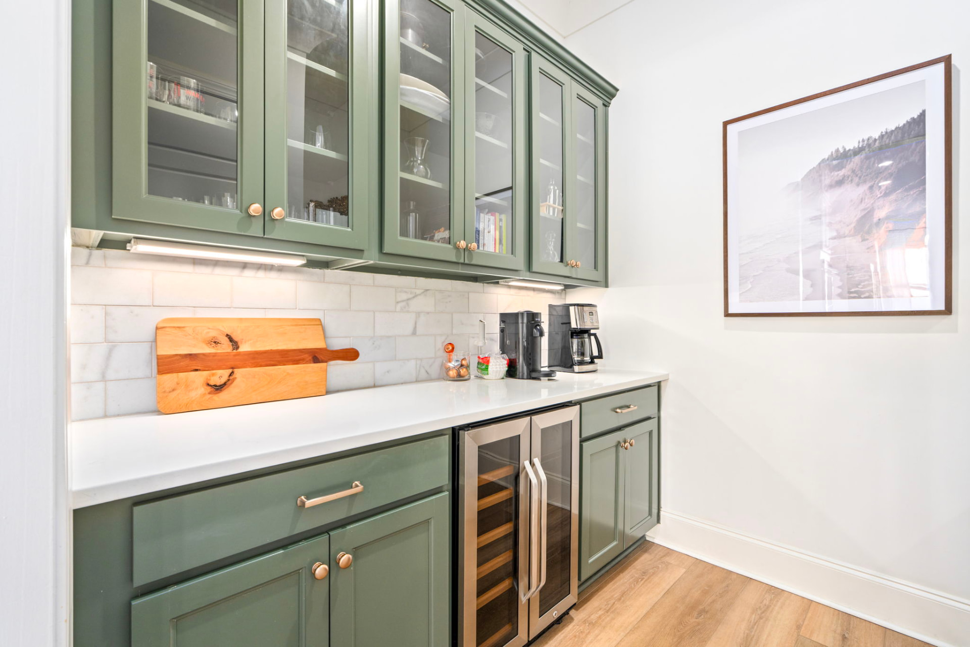 Butler's pantry with sage green cabinets, marble backsplash, coffee bar and wine fridge
