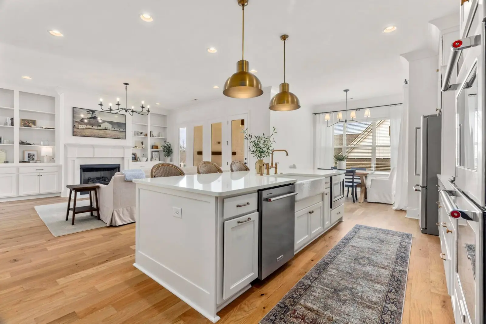 Kitchen island with farmhouse sink open to the great room and fireplace